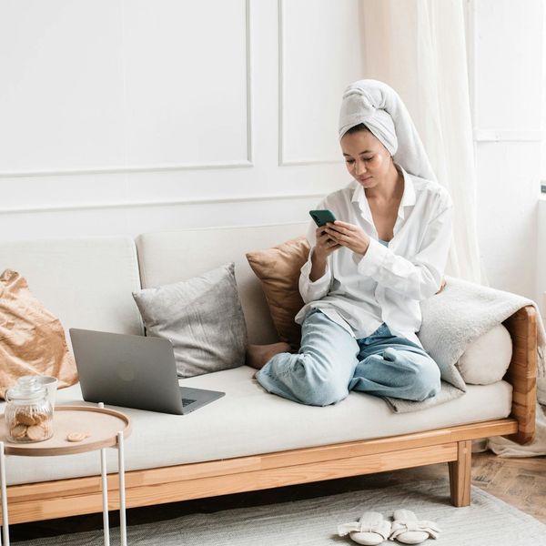 Person looking serene in a bright, minimalist room.